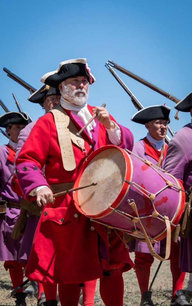 Vibrant reenactment of a historical parade with drummers in traditional Spanish military attire.